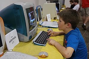Kid playing on iMac (16728580353)
