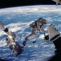STS112 EVA 1 David Wolf anchored to SSRMS