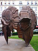 a tall open patinated bronze sculpture