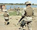 Three marines patrol along the Euphrates River during Operation Iron Fist