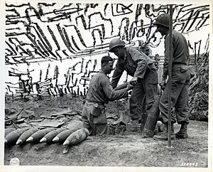Artillery men pile up 155-mm ammunition