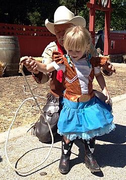 Lasso expert Dave Thornbury teaches Berlin, daughter of Western children's author Lorin Morgan-Richards, a new trick at the Santa Clarita Cowboy Festival.