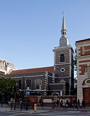 A brick church similar to First Congregational, in an urban setting, seen from its side, with quoins and a centrally located clock tower at the front