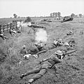 Home Guard troops 'fighting' Valentine tanks of 6th Armoured Division during large-scale manoeuvres at Yelden in Bedfordshire, 27 July 1941. H12081