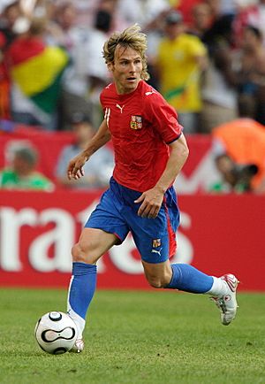 Nedvěd wearing the red shirt, blue shorts and blue socks of the Czech Republic