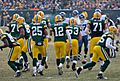 Quarterback Aaron Rodgers (12) and the Packers break the huddle.
