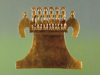 Museo del Oro pectoral, six birds with folded wings and crouching human figures on their heads