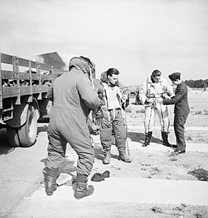 The crew of a Boeing Fortress Mk I of No. 90 Squadron RAF putting on electrically-heated flying suits at Polebrook, Northamptonshire, before taking off for a high-altitude bombing attack on the German battlecru CH3090