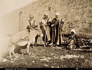 A group of lepers in Jerusalem; three standing men with stic Wellcome V0029715