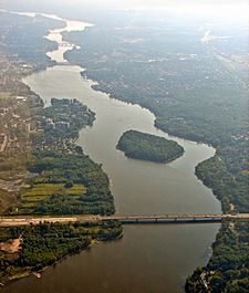 Aerial view looking east, of Rivière des Prairies with Louis Bisson Bridge in the foreground. The island "Ile aux Chats" can be seen near the centre.