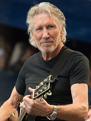 Roger Waters playing acoustic guitar