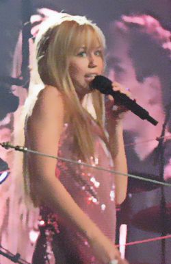 Miley Cyrus, performing as the Hannah Montana character, on the stage at a November 2007 concert.