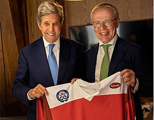 John Kerry and Slava Fetisov holding a sports jersey