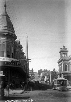 View west on 2nd at Spring; Hollenbeck Block when two stories (left), 2nd City Hall (right), 1886