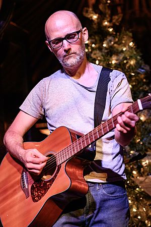 Moby playing his guitar in 2018