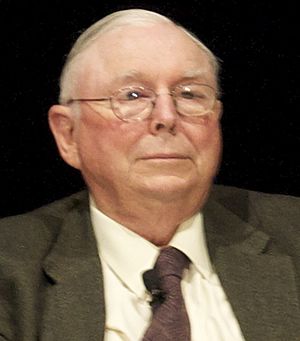 Munger seated, wearing a suit