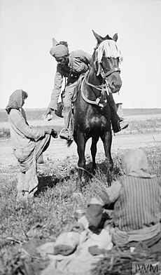 Indian Cavalryman shares his rations with starving Christian girls, Mesopotamia