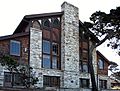 Photograph of Merrill Hall at the Asilomar Conference Grounds, a tall and broad peaked building of wood and stone.