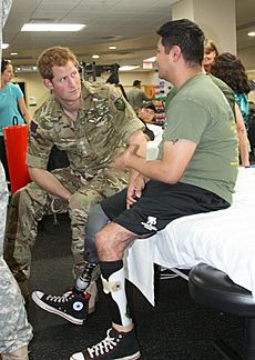 Prince Harry talks to an injured soldier