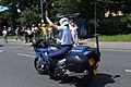 Gendarmerie motor officer raising arm in traffic