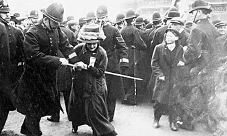 A policeman tries to seize a banner from a suffragette on Black Friday