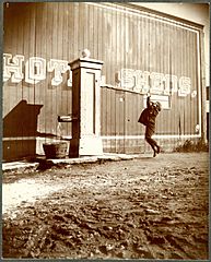 Unidentified boy using Weissbein's roadhouse pump well, Caton Street, Brooklyn, New York City, November 1, 1898