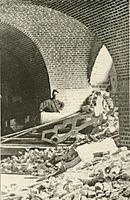cannon in a brick room under collapsed rubble