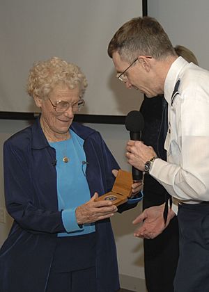 Iris Critchell receives an SMC coin from SMC Vice Commander Brig Gen. Neil McCasland