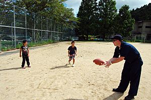US Navy 070826-N-4124C-048 Hull Maintenance Technician 1st Class Jamey K. Parks, assigned to USS Juneau (LPD 10), plays catch with kids at the Tenshin-ryo Children's Home.jpg