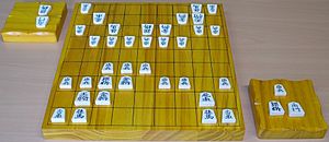 Shogi board pieces and komadai.jpg