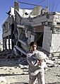 Sumayya and her cat in front of her demolished home 2002, 2nd Intifada
