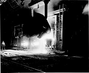 Photograph of a Vat of Molten Pig Iron Being Poured into a Open Hearth Furnace at the Jones and Laughlin Steel Company, Pittsburgh, Pennsy - NARA - 535922 (high contrast)