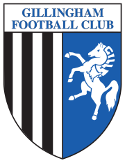 A shield with the words "Gillingham Football Club" in the top portion and the remainder divided into two sections, the left containing black and white vertical stripes and the right a depiction of a white horse rearing up on its hind legs on a blue background