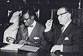 Patrice Lumumba signs the document granting independence to the Congo next to Belgian Prime Minister Gaston Eyskens