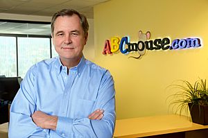 Doug Dohring at Age of Learning with ABCmouse sign