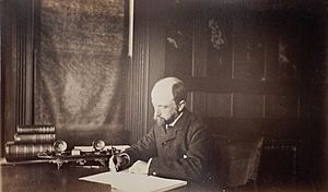 Henry Adams seated at desk in dark coat, writing, photograph by Marian Hooper Adams, 1883