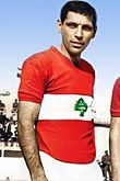 Joseph Abou Mrad wearing a red Lebanese jersey with a green cedar in the center inside a white horizontal band