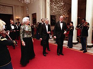President George H. W. Bush and Barbara Bush escort Prime Minister Tadeusz Mazowiecki of Poland at a State Dinner at the White House