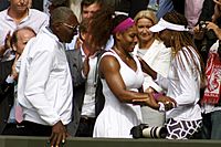 Serena Williams embraces Venus Williams as Father looks on