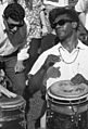 Two hand drummers, both wearing sunglasses, about 1966