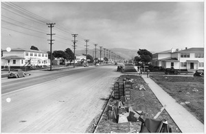 "4,000 Unit Housing Project Progress Photographs March 6,1943 to August 11, 1943, Looking down a street towards the... - NARA - 296755