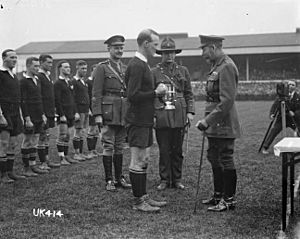 King George V presents a cup to the captain of the winning New Zealand Services Rugby Team, London