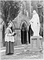 Cardinal Norman Thomas Gilroy standing near a statue of the Virgin Mary