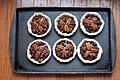 Chocolate Pecan Tarts on a baking sheet