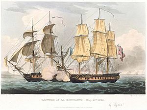 Two single decked warships, one flying a French flag and the other a British flag fire at one another through heavy smoke with land and other ships in the distance.