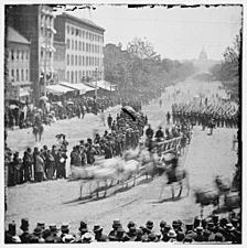 Washington, District of Columbia. Grand Review of the Army. Infantry unit with fixed bayonets followed by ambulances passing on Pennsylvania near the Treasury LOC cwpb.02831
