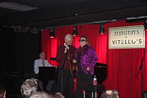 Alex Trebek and Don McLean onstage at Trebek's annual Christmas Party