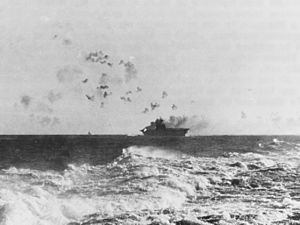 USS Enterprise (CV-6) under attack and burning during the Battle of the Eastern Solomons on 24 August 1942 (NH 97778)