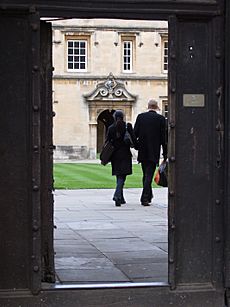 Couple walking into St Johns College Oxford