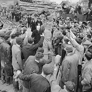 Winston Churchill is cheered by workers during a visit to bomb-damaged Plymouth, 2 May 1941. H9265.jpg